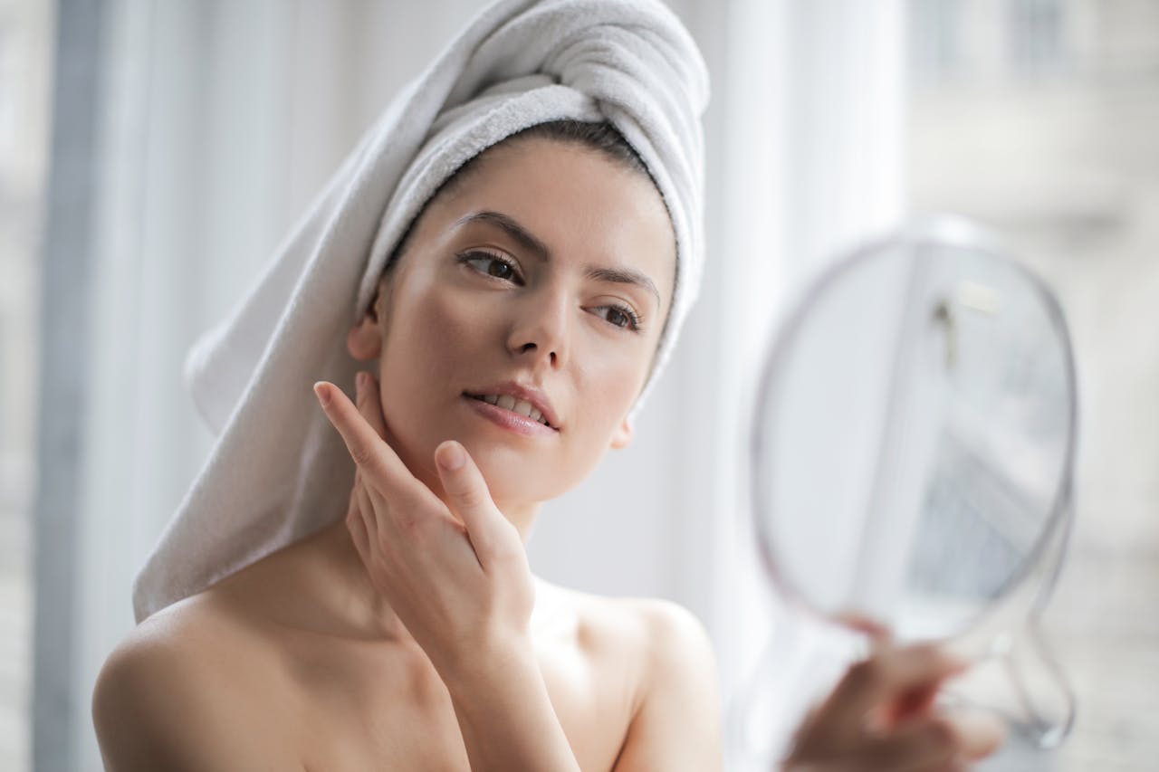 The Art of Drawing Readers In: Your attractive post title goes here A serene and elegant woman enjoys a skincare ritual, enhancing her natural beauty in the comfort of her home.